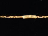 an image of a gold bracelet on a black background