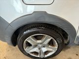 a close up of a car ' s tire on the side of the road