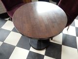 a table and two chairs in a room with black and white checkered floor