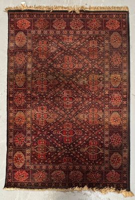 an old rug hanging on a wall in a room