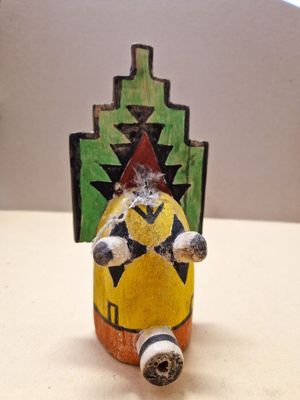 a small figurine of a man sitting on top of a table
