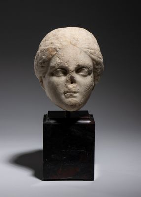 a white marble head of a woman on a black stand