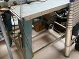 a workbench that has a table with a machine on it