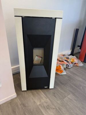 a black and white fireplace in the corner of a room