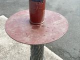 a red cup sitting on top of a red fire hydrant