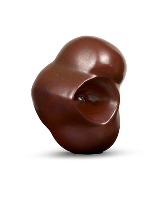 a chocolate sculpture on a white surface with a white background