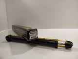 a close up of a pen sitting on top of a white table