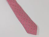 a close up of a red and white tie on a white surface