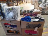 many boxes of clothing and a fan in a warehouse