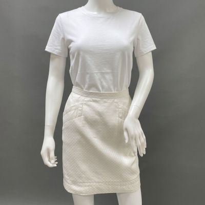 a mannequin wearing a white shirt and skirt on a mannequin mannequin