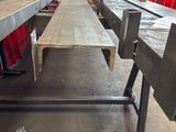 a long bench that is in a room with red curtains
