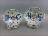 pair of blue and white plates with flowers on them