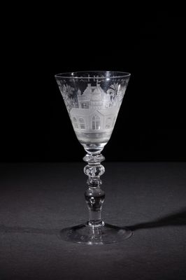 a wine glass with a picture of a city on it