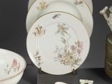 a lot of plates and bowls that are sitting on a table