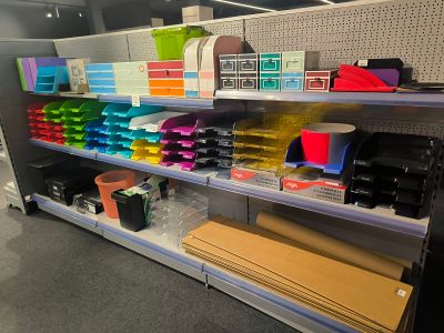 a lot of office supplies on the shelves in the store