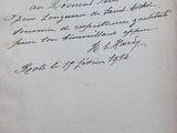 an old book with a handwritten letter on the front of it
