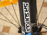 a close up of a bike with a yellow handlebar