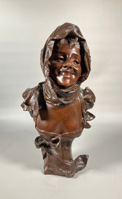 an antique bronze bust of a child with a hood on