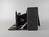 an old camera and a book on the table