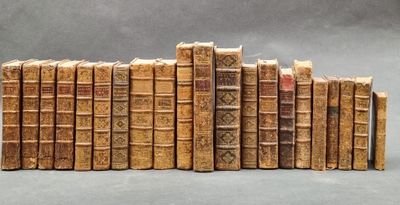 several old books stacked on top of each other on a table