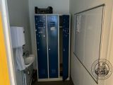 a small bathroom with a blue locker next to a white sink
