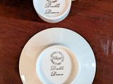 two cups and saucers sitting on a wooden table
