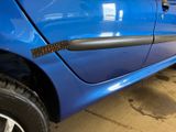 a close up of a blue car with a black door handle