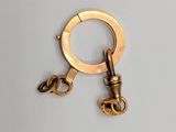 a gold keychain with a chain attached to it