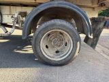 a flat tire on a flatbed truck parked on the side of the road