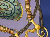 a close up of a tie with a pair of scissors on it