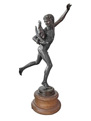 bronze statue of a woman holding a child on a pedestal