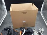 a box of tools sitting on the floor next to a pair of clamps