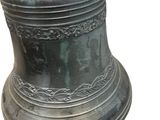 a large metal bell with a rusted top on a white background
