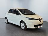 a white car is parked in a room with a gray floor