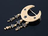a close up of a crescent and stars broochle on a black surface