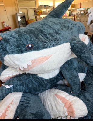 a stuffed shark that is sitting on top of another stuffed shark