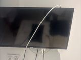 a cat that is sitting on a tv that is on the wall