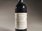 a bottle of red wine sitting on top of a table