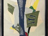 tableau représentant des formes et des couleurs abstraites, encadré de noir et accroché au mur
