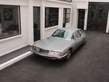 a silver car parked in front of a building