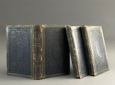 three old books sitting on top of each other on a table