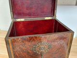 a wooden box with a tree on it sitting on a wooden floor