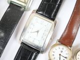 several different types of watches are lined up on a white surface