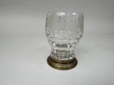 a glass cup that is sitting on top of a table