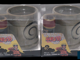 two cups that are in a box on the table