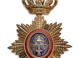 a close up of a medal with a crown on top of it