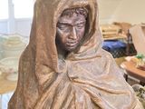 a statue of a woman holding a knife in her hands