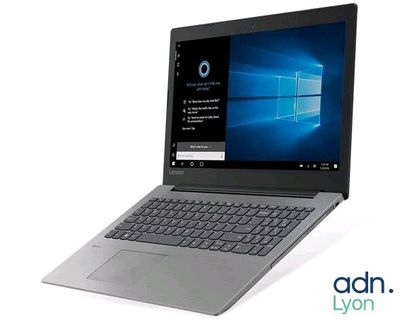 the laptop is open on a white surface with windows on the screen