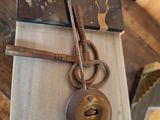 a clock with a key and a book on a table