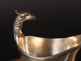 a silver bowl with an eagle head on it